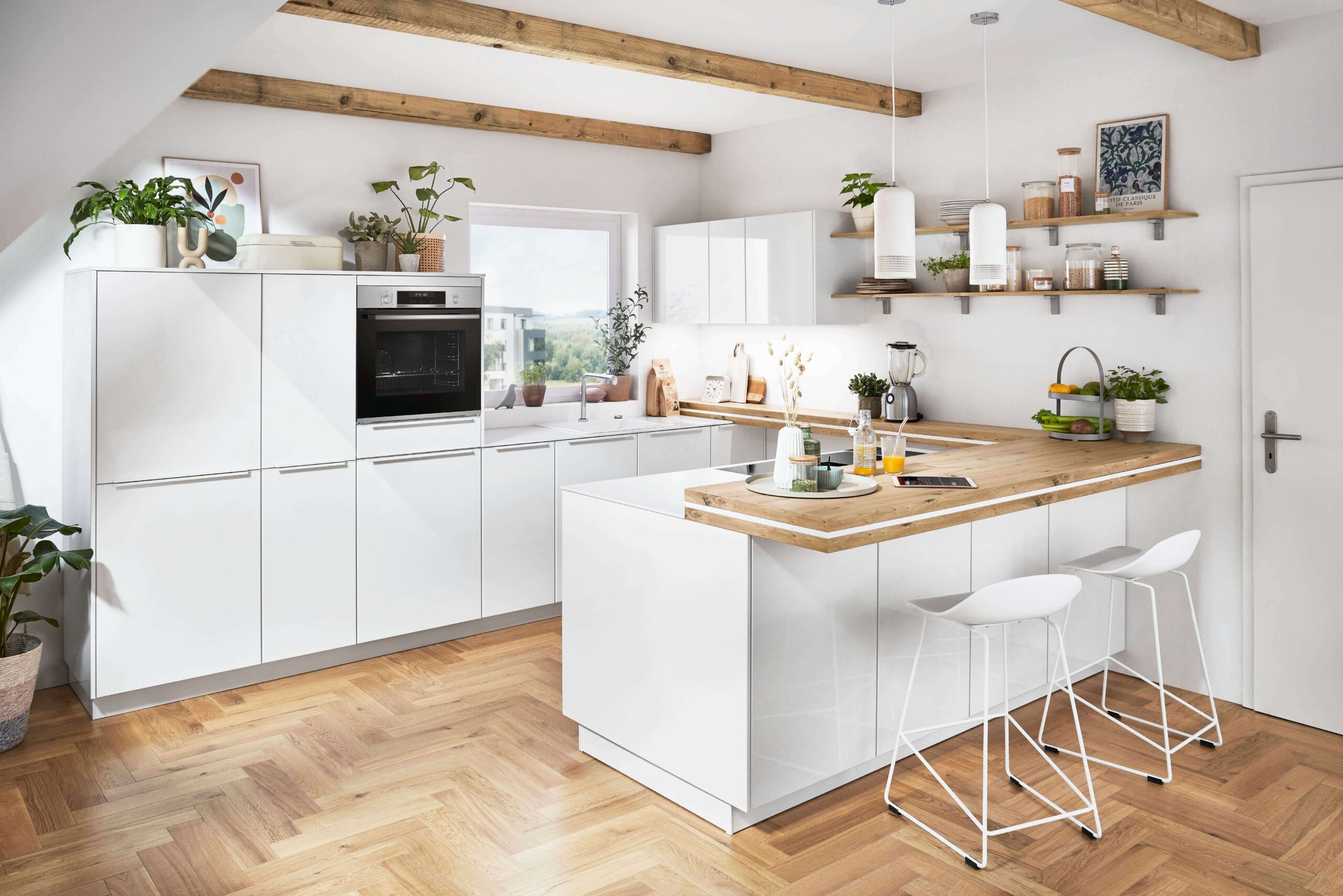 Bright white kitchen with a light wood countertop island, white bar stools, open shelving, wood beams, and light wood floors.