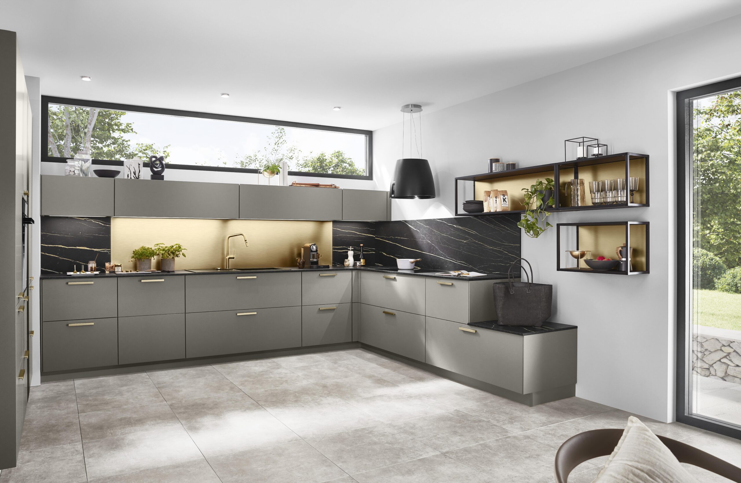 Gray and gold kitchen with an L-shaped layout, black marble backsplash, and open shelving. A large window brightens the space.