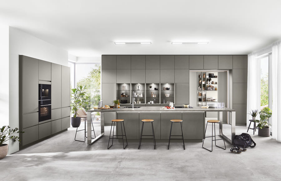 A minimalist grey kitchen with hidden appliance storage. Explore different design approaches to learn how to hide appliances in a kitchen and maintain a clean aesthetic.