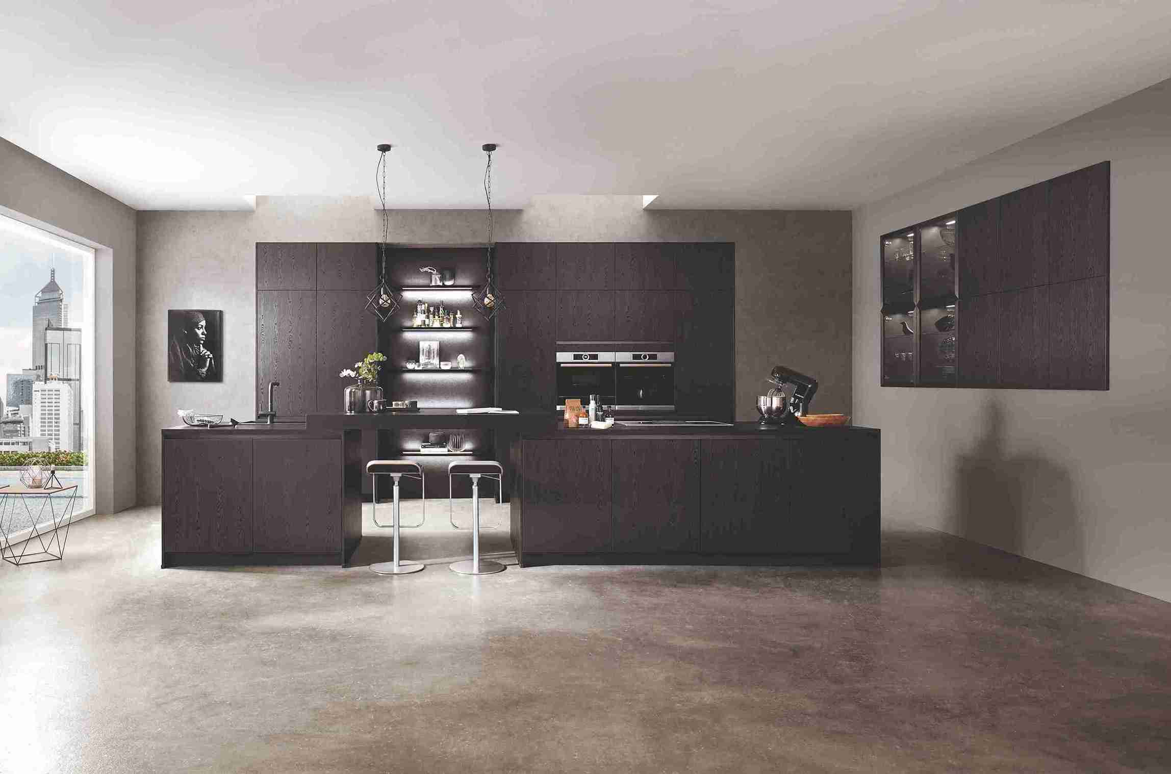 A custom-made kitchen with dark wood cabinetry and a large island, showcasing the possibilities of bespoke joinery and high-end design.