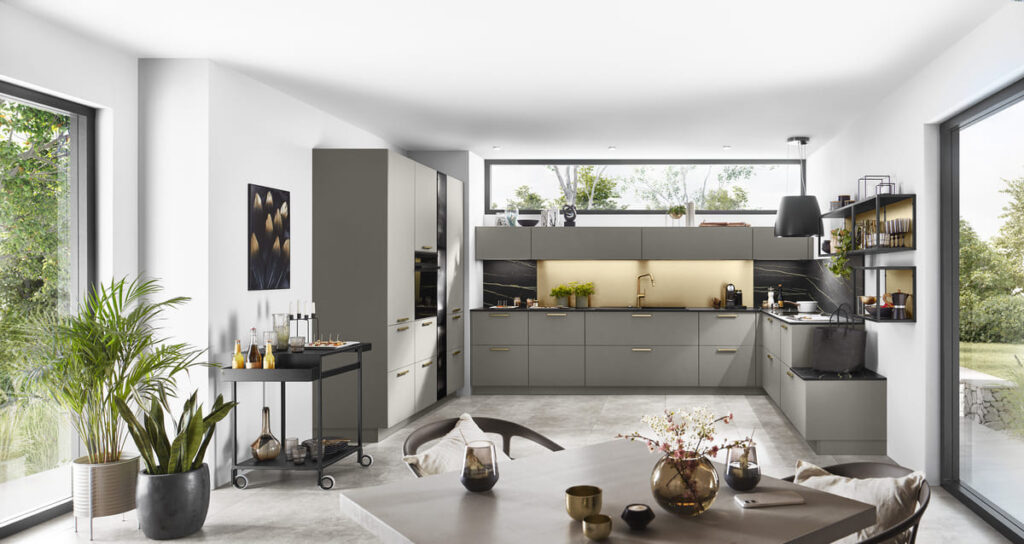 Contemporary grey kitchen in Thailand with minimalist design and large windows.