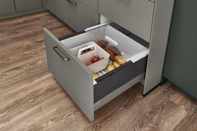 A kitchen drawer designed for vegetable storage, showcasing a practical element of eco kitchen design for preserving fresh produce.