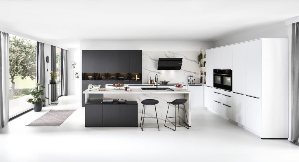 Elegant black and white kitchen in Bangkok featuring marble accents and large windows for a bright, stylish space.