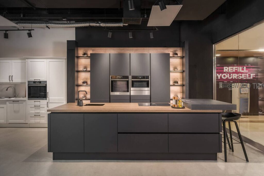 Elegant graphite black kitchen on display in a Bangkok showroom, showcasing modern design.