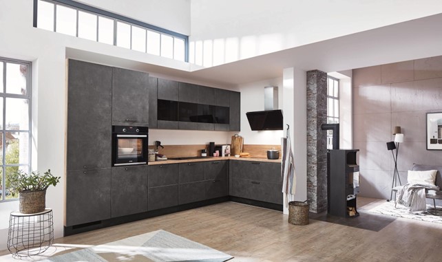 This kitchen incorporates wood countertops and open shelving for a natural and inviting feel. The exposed brick wall adds a rustic element.