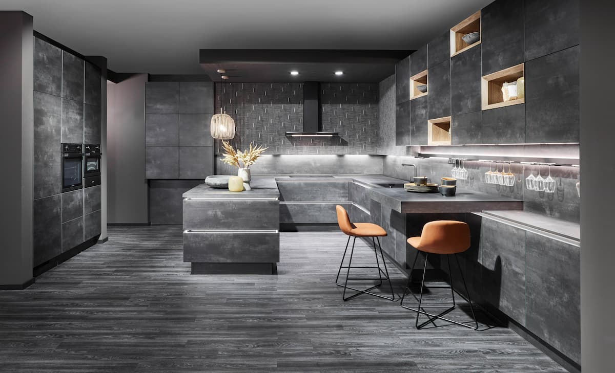 A striking industrial gray kitchen with bold textures and modern lighting, showcasing an innovative approach to modern kitchen interior design with a futuristic feel.