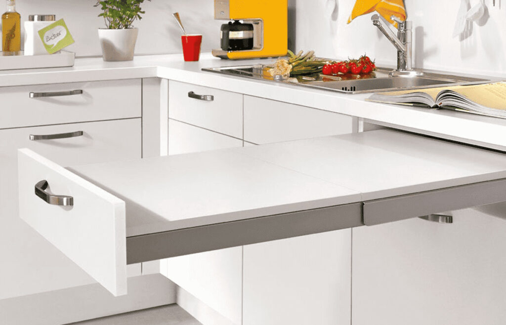 Innovative built-in extendable table with sleek white finish and stainless steel handle.