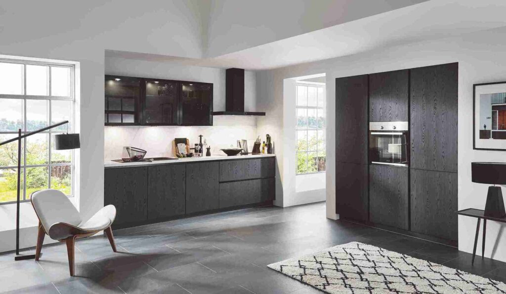 This minimalist black and glass kitchen provides kitchen design tips for creating a sleek and sophisticated space.
