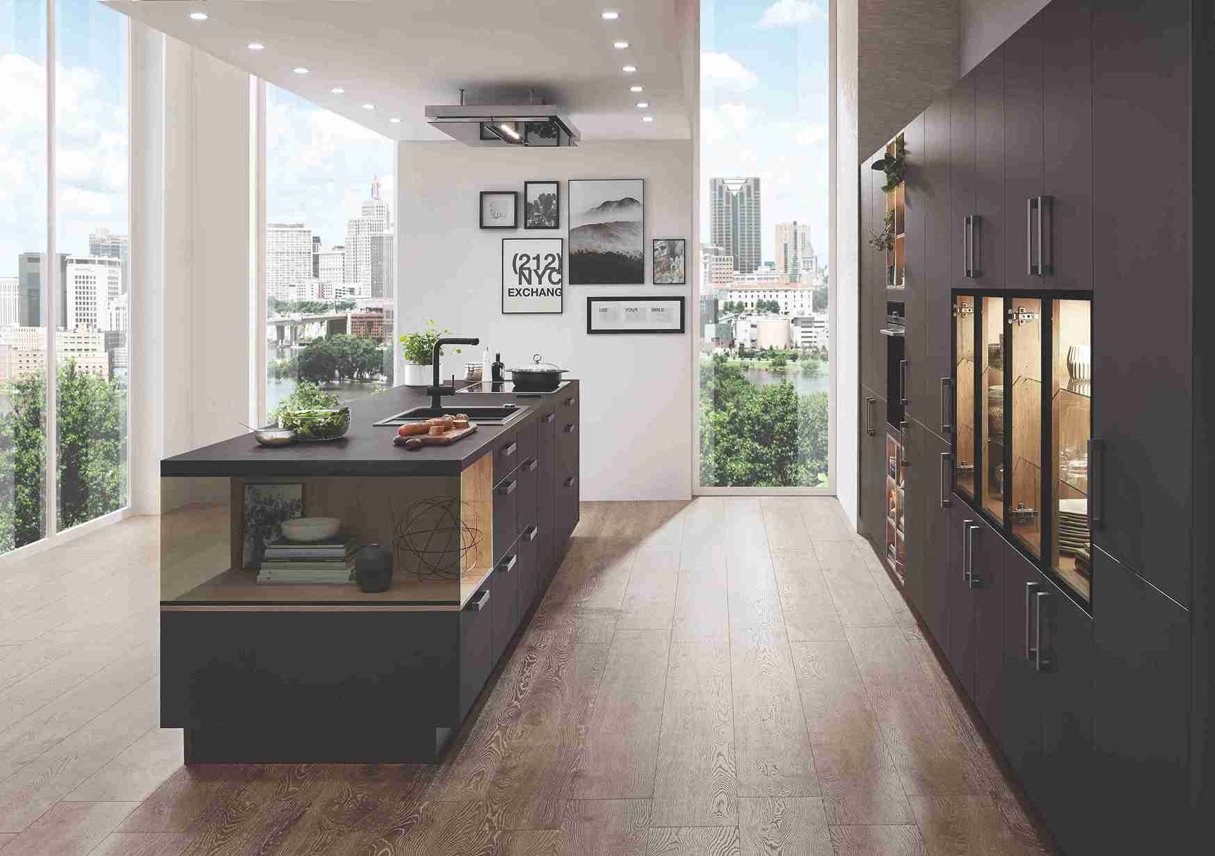 A dark brown kitchen with a striking city view features wood-look flooring, prompting consideration of the best kitchen flooring material for a luxurious, modern space.