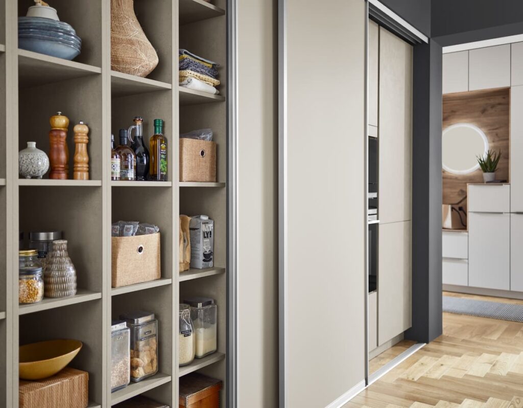 A well-organized kitchen pantry with sliding doors. Incorporate smart storage solutions into your kitchen plan drawings to optimize space utilization.