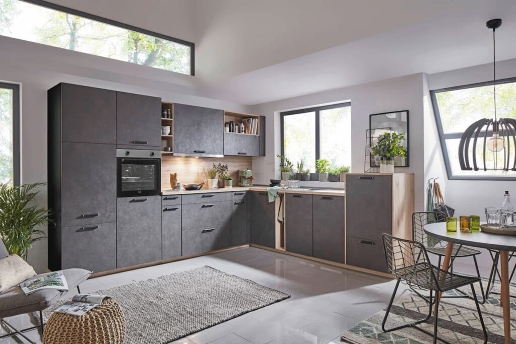A modern grey kitchen with wood accents and ample natural light. Use this image as inspiration when researching how much to spend on a kitchen that reflects your style.