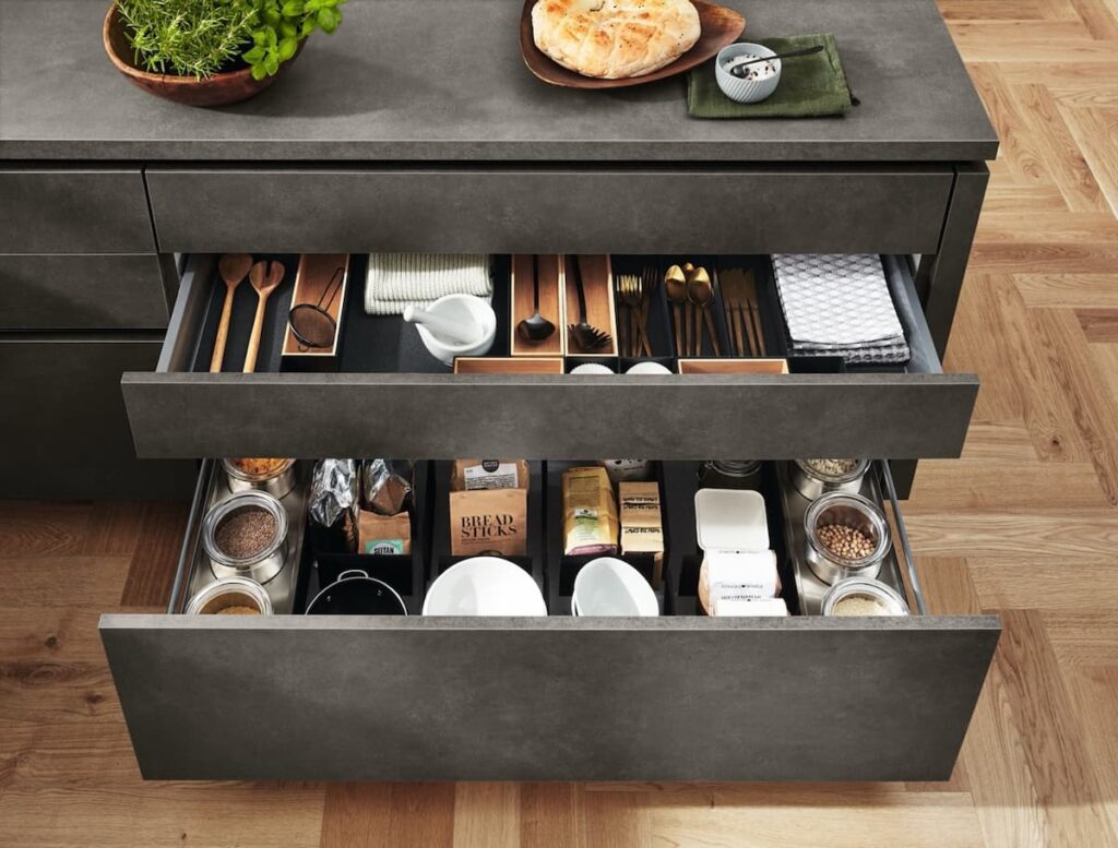 Well-organized kitchen drawers showcasing clever storage solutions. Factor in storage features when determining how much to spend on a kitchen to maximize functionality.