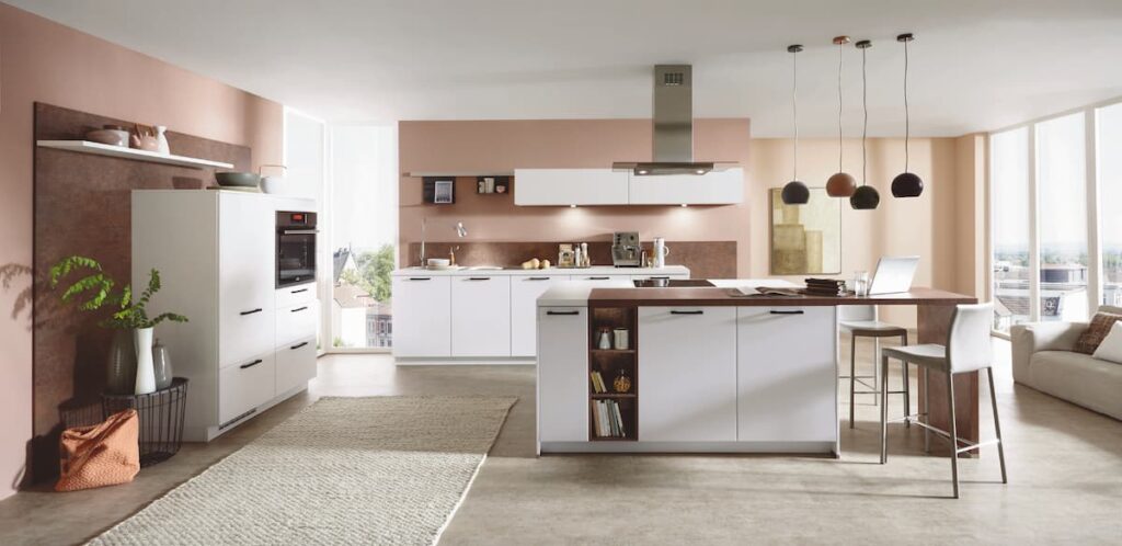 A minimalist white kitchen with wooden accents, showcasing a luxury design with a focus on simplicity and high-end finishes.