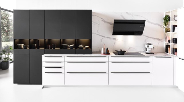 Modern luxury kitchen interior design featuring a striking contrast of sleek black and white cabinets, with integrated appliances and elegant marble backsplash.