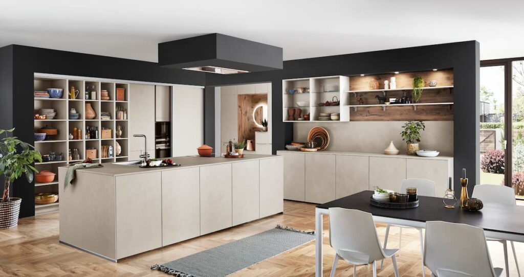 A minimalist L-shaped modular kitchen interior design with light beige cabinets and open shelving, creating a clean and spacious environment for modern living.