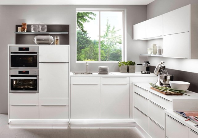 
Image 01 Alternative Text 

A bright, minimalist white kitchen with integrated appliances, showcasing the clean lines and reflective surfaces often achieved when selecting the best material for kitchen cabinets. 