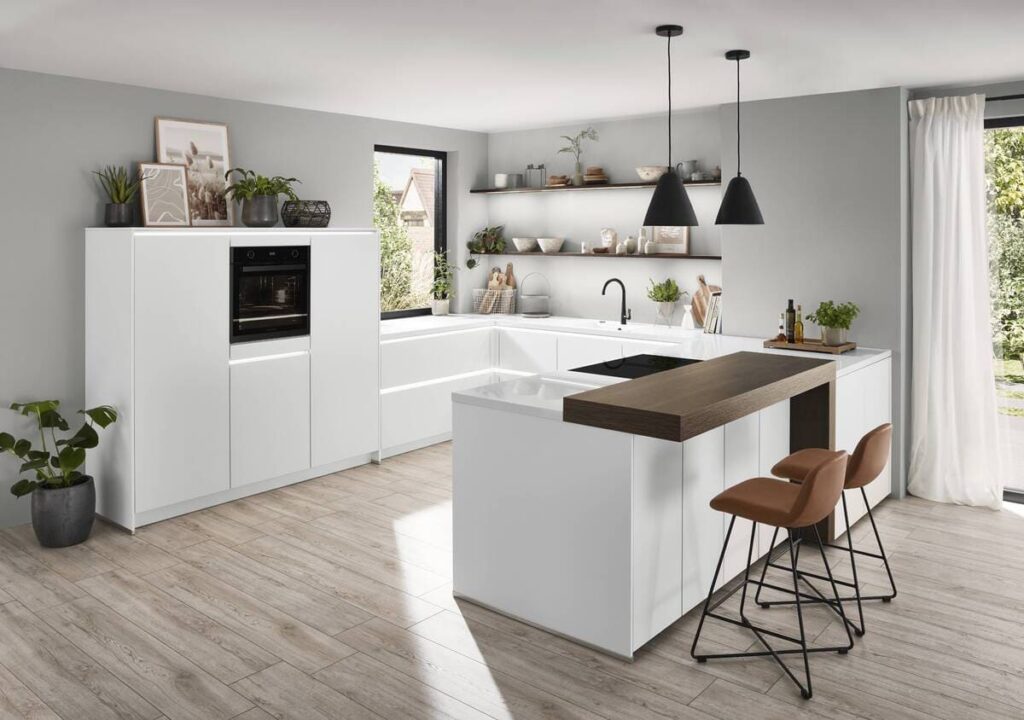 Minimalist white kitchen with wooden accents and modern interior design elements, creating a fresh and airy space.