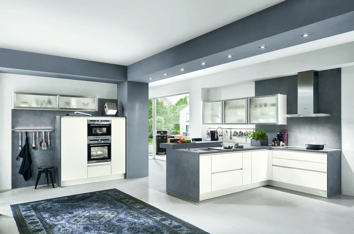 Minimalist white kitchen in Thailand featuring clean lines and modern fixtures.