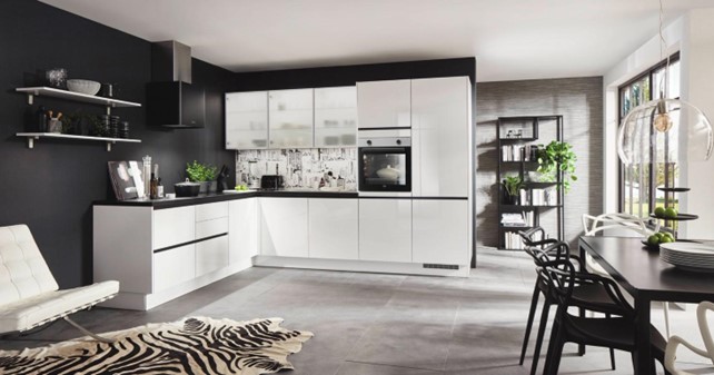 Stylish L-shaped kitchen interior design featuring sleek white cabinets, black accents, and a modern dining area, showcasing tips and trends for a functional and elegant kitchen layout.