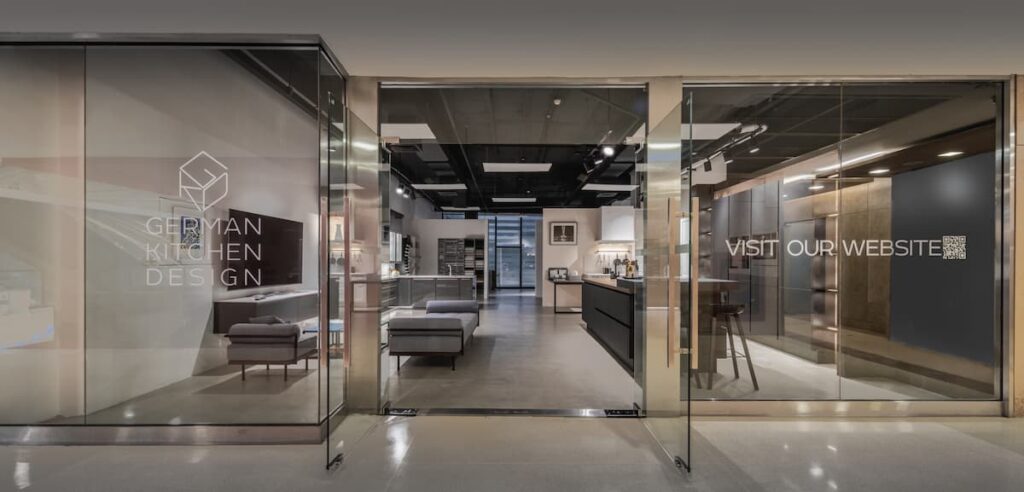 Entrance to a modern German Kitchen Design showroom featuring innovative layouts and premium appliances.