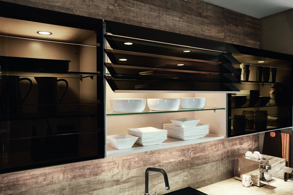 Modern kitchen with glass-fronted cabinets and sophisticated interior design, adding a touch of elegance.