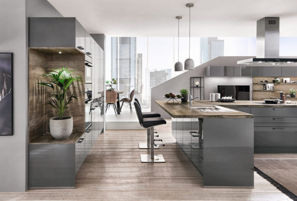 A modern kitchen design with glossy gray cabinets, wooden accents, and glass elements.