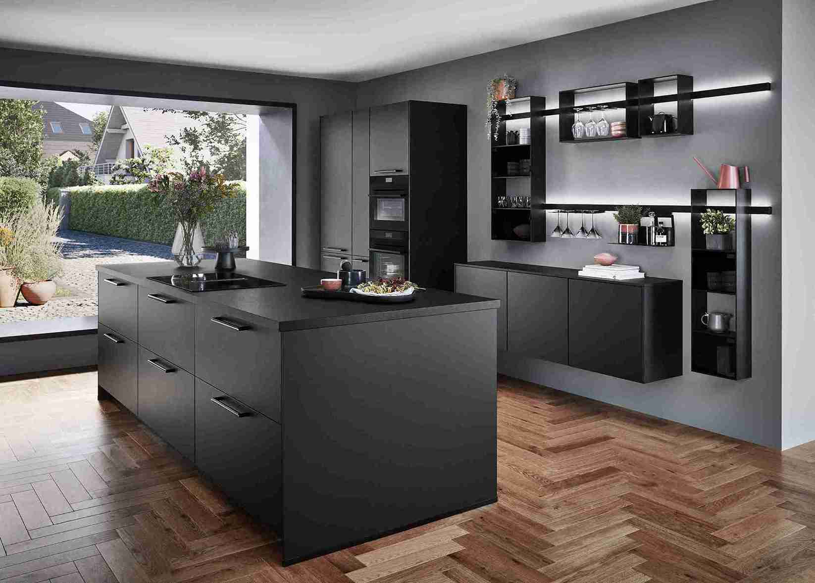 A contemporary black kitchen by a top modern kitchen company, showcasing a large island, open shelving, and dark wood flooring.