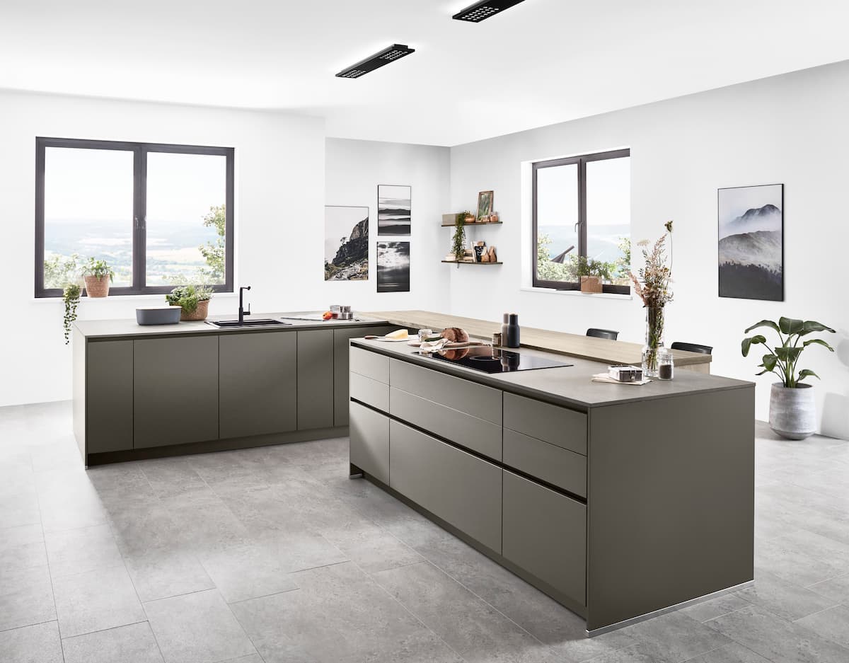 A modern minimalist kitchen with slate gray cabinets and sleek design, featuring durable and stylish high-traffic flooring material ideal for busy households.