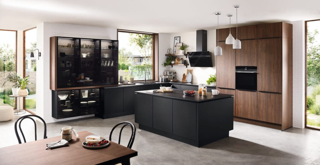 Modern Thai kitchen design with sleek black cabinets, wooden accents, and natural light.