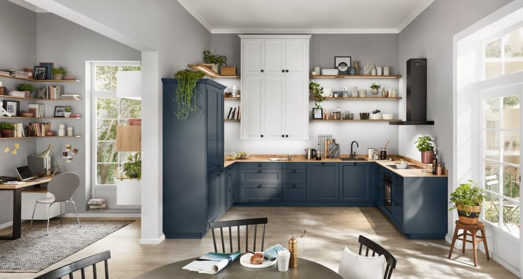 A traditional navy kitchen with white accents, natural wood countertops, and durable high-traffic flooring material that blends functionality and style.