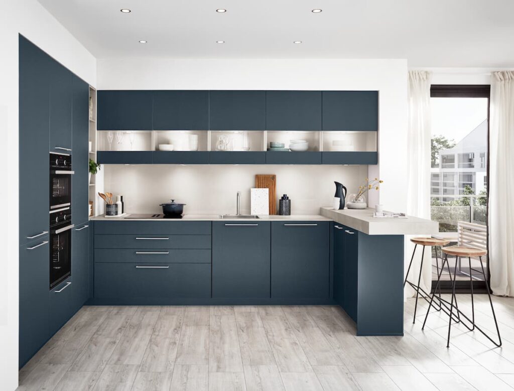This kitchen combines elegant ocean-blue modular cabinets made from the best material for modular kitchen cabinets, creating a fresh and sophisticated cooking space.