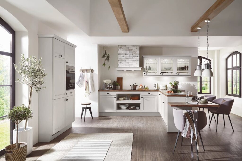 A charming rustic kitchen design featuring the best material for modular kitchen cabinets, with white cabinetry and wood accents, blending traditional and modern styles.