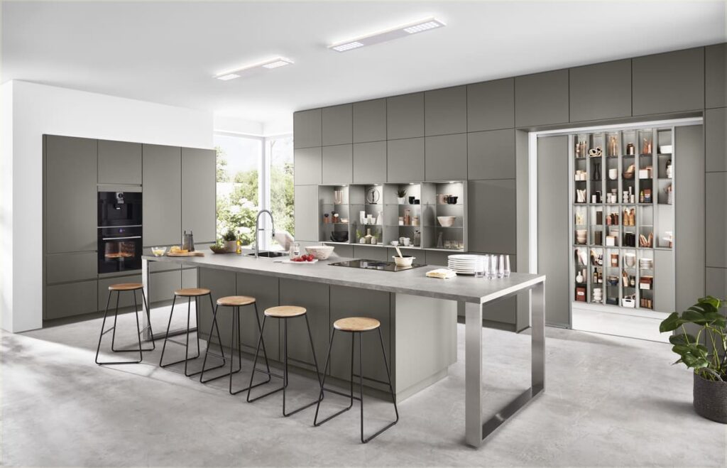 Sleek built-in kitchen furniture with a spacious island and integrated appliances, offering a stylish and efficient workspace.