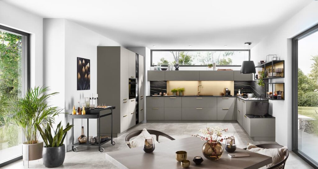 Spacious modern kitchen with neutral tones, large windows, and concrete flooring, ideal for kitchen interior design ideas that maximize natural light.