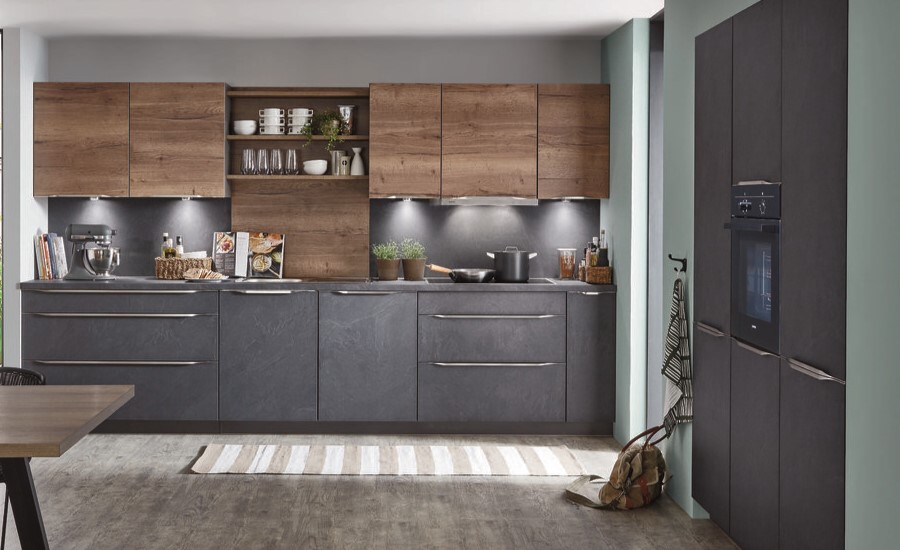 A modern kitchen featuring stone gray cabinets paired with rustic wood accents and a green accent wall.