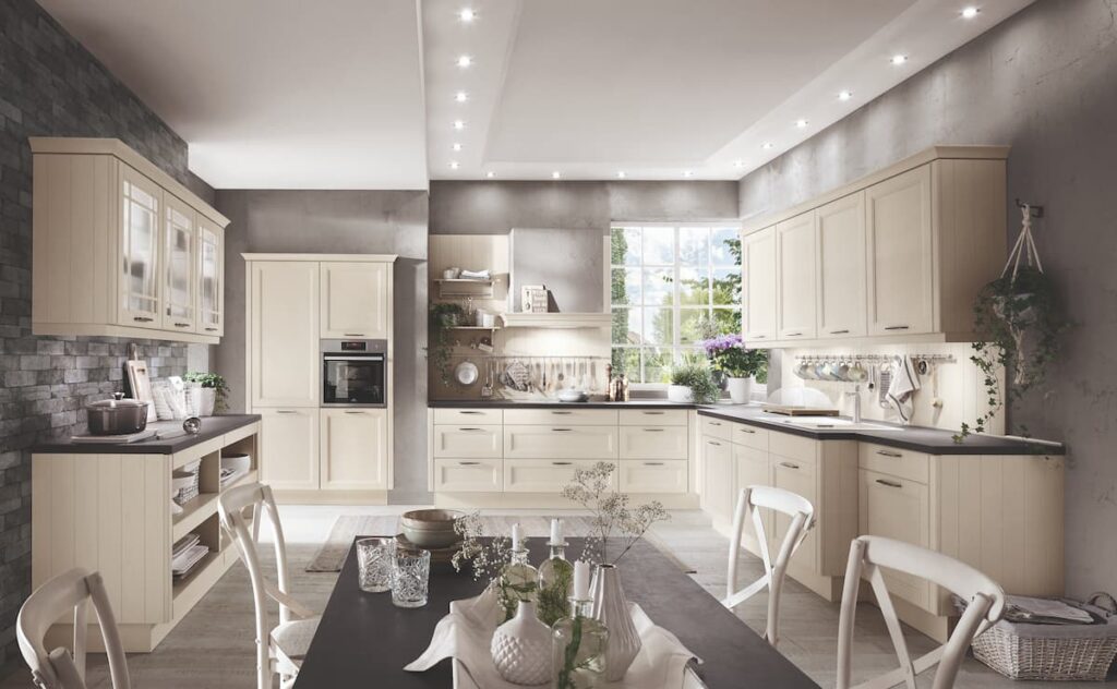 A cream traditional kitchen flooded with natural light, offering a classic luxury aesthetic.