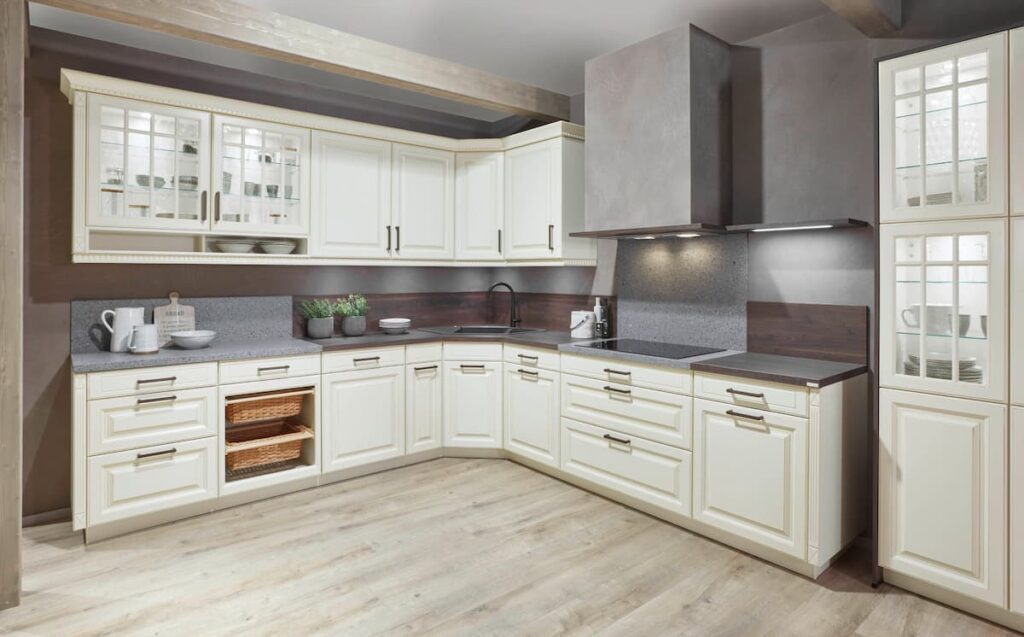 A warm, vintage-inspired kitchen with cream cabinets and modern accents, merging traditional charm with modern kitchen interior design for a balanced aesthetic.