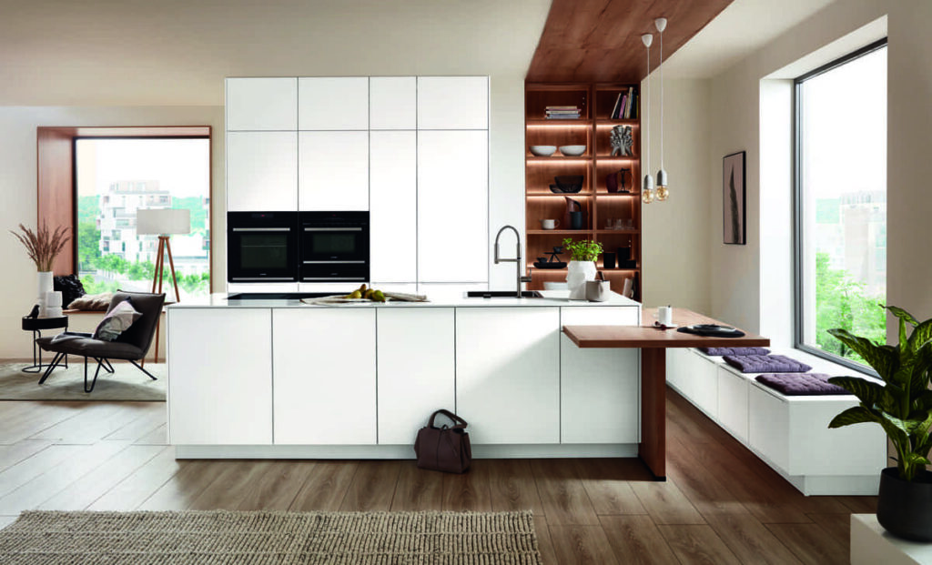 Warm and contemporary white kitchen in Bangkok with clean lines, integrated seating, and stylish functionality.