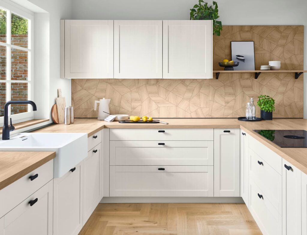 White framed cabinets paired with a rustic wood island and open shelving, representing a modern take on country kitchens.