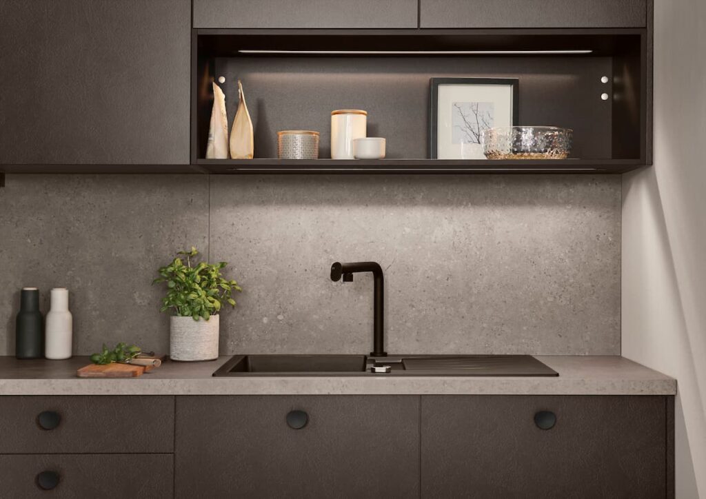 High gloss taupe grey kitchen cabinets with integrated niche lighting for a luxe natural living look.