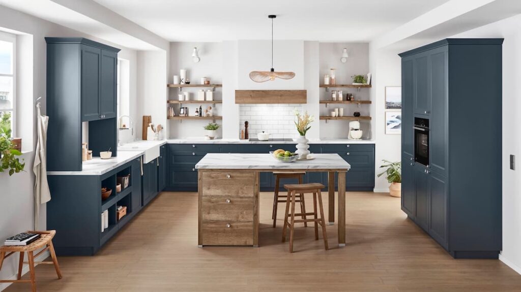 A high-end blue kitchen featuring precision-engineered cabinetry, demonstrating the durability and finish of a professional built in kitchen.